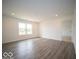 Spacious living room with window and modern hard surface floors at 6623 Sulgrove Pl, Indianapolis, IN 46221