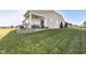 Landscaped backyard with a covered patio and a retaining wall at 12535 Tidecrest Dr, Fishers, IN 46037