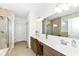 Spa-like bathroom with double vanity, large mirror, and shower at 12535 Tidecrest Dr, Fishers, IN 46037