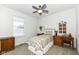 Cozy bedroom with twin bed, dresser, and a ceiling fan at 12535 Tidecrest Dr, Fishers, IN 46037