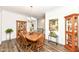 Bright dining room features hardwood floors, wood table and chairs, and built-in hutch at 12535 Tidecrest Dr, Fishers, IN 46037