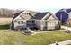 Attractive stone and shingle exterior of a charming ranch home with a manicured lawn at 12535 Tidecrest Dr, Fishers, IN 46037