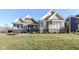 House exterior showcasing stone and siding with a well-maintained lawn at 12535 Tidecrest Dr, Fishers, IN 46037