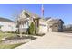 Two-car garage with stone exterior and a spacious driveway at 12535 Tidecrest Dr, Fishers, IN 46037