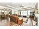 Relaxing Gathering room with hardwood floors, fireplace, and large windows offering natural light at 12535 Tidecrest Dr, Fishers, IN 46037