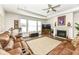 Spacious Gathering room features hardwood floors, fireplace, and comfortable leather sectional sofa at 12535 Tidecrest Dr, Fishers, IN 46037