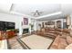 Open Gathering room includes hardwood floors, a fireplace and a large sectional leather sofa at 12535 Tidecrest Dr, Fishers, IN 46037