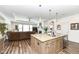 Open kitchen features a large granite island, stainless steel appliances, and views to Gathering room at 12535 Tidecrest Dr, Fishers, IN 46037