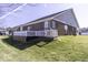 A backyard and a wood deck with white railings. A perfect view for the morning at 4326 Switchgrass Way, Indianapolis, IN 46237