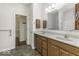 Double vanity bathroom with a walk-in shower and access to closet at 4326 Switchgrass Way, Indianapolis, IN 46237