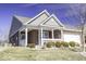 Charming brick home featuring a cozy covered porch with white railings and a well-manicured lawn at 4326 Switchgrass Way, Indianapolis, IN 46237