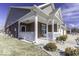A brick home featuring a covered porch with white railings and a walkway at 4326 Switchgrass Way, Indianapolis, IN 46237