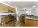 Kitchen with granite island, stainless steel appliances, and hardwood floors at 4326 Switchgrass Way, Indianapolis, IN 46237