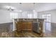 Kitchen island with granite countertop and sink, open to dining area at 4326 Switchgrass Way, Indianapolis, IN 46237