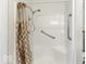 Walk-in shower with grab bars and patterned shower curtain at 4326 Switchgrass Way, Indianapolis, IN 46237