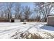 Large backyard with sheds and playset, partially covered in snow at 3359 Laurel St, Indianapolis, IN 46227