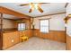 Dining room with wood paneling, yellow chair and a window at 3359 Laurel St, Indianapolis, IN 46227