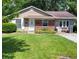 Tan house with brick accents, green lawn, and a partially visible driveway at 3359 Laurel St, Indianapolis, IN 46227