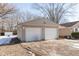 Double-car garage with white doors and tan siding at 3359 Laurel St, Indianapolis, IN 46227