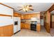 Kitchen with oak cabinets, black appliances, and vinyl flooring at 3359 Laurel St, Indianapolis, IN 46227