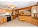 Kitchen with oak cabinets, black appliances, and light flooring at 3359 Laurel St, Indianapolis, IN 46227