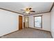 Bright living room featuring carpeted floors and a ceiling fan at 3359 Laurel St, Indianapolis, IN 46227