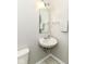 Compact half-bathroom with tile floors and a small sink vanity and mirror at 5171 Alpine Violet Way, Indianapolis, IN 46254