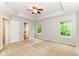Spacious bedroom with a ceiling fan, neutral paint, and windows offering natural light at 5171 Alpine Violet Way, Indianapolis, IN 46254