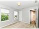 Bright bedroom featuring neutral walls and carpet, and 2 windows and a bathroom door at 5171 Alpine Violet Way, Indianapolis, IN 46254