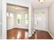 Inviting foyer with gleaming hardwood floors and abundant natural light streaming through the front door at 5171 Alpine Violet Way, Indianapolis, IN 46254