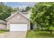 Charming two-story home featuring a well-manicured lawn and an attached two-car garage at 5171 Alpine Violet Way, Indianapolis, IN 46254