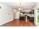Open kitchen with stainless steel appliances, dark wood cabinets, and eat-in space at 5171 Alpine Violet Way, Indianapolis, IN 46254