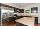 Well-equipped kitchen with stainless steel appliances, island, and dark cabinetry at 5171 Alpine Violet Way, Indianapolis, IN 46254