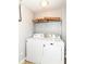 Functional laundry room with washer, dryer, and storage shelf at 5171 Alpine Violet Way, Indianapolis, IN 46254