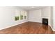 Spacious living room with wood floors, a fireplace, and lots of natural light at 5171 Alpine Violet Way, Indianapolis, IN 46254