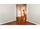 An open room with hardwood floors provides access to the stairway and glimpses of the dining room at 5171 Alpine Violet Way, Indianapolis, IN 46254