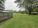 Expansive backyard featuring a large grassy area with mature trees and shelter, perfect for outdoor activities at 8418 S State Road 39, Clayton, IN 46118