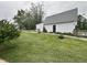 Private backyard featuring a detached garage, well-maintained lawn and partial fence, ideal for recreation at 8418 S State Road 39, Clayton, IN 46118