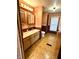 Bathroom featuring double sink vanity, laminate floors and neutral color palette at 8418 S State Road 39, Clayton, IN 46118