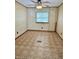 Neutral bedroom with ceiling fan, window with blinds, and unique patterned tile floor at 8418 S State Road 39, Clayton, IN 46118