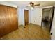 Comfortable bedroom features a ceiling fan, wood-look flooring, closet, and natural light at 8418 S State Road 39, Clayton, IN 46118