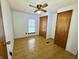 Comfortable bedroom features a ceiling fan, wood-look flooring, closet, and natural light at 8418 S State Road 39, Clayton, IN 46118