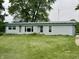 Charming single-story home with a well-manicured lawn, a metal roof, and attractive curb appeal at 8418 S State Road 39, Clayton, IN 46118