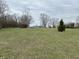 Expansive front yard featuring a well-manicured lawn and mature trees offering ample space for outdoor activities at 8418 S State Road 39, Clayton, IN 46118