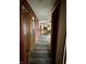 Hallway view shows the layout with wood-look floors, leading to various rooms and kitchen space at 8418 S State Road 39, Clayton, IN 46118