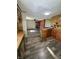 Kitchen area with open layout leading into other rooms, showcasing the new flooring at 8418 S State Road 39, Clayton, IN 46118