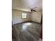 Spacious living room features new vinyl flooring, a ceiling fan and plenty of natural light from the window at 8418 S State Road 39, Clayton, IN 46118