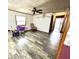 A spacious living room with laminate flooring, patterned wallpaper and overhead lighting at 8418 S State Road 39, Clayton, IN 46118