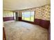 Bright living room featuring floral wallpaper, carpet flooring and large window at 8418 S State Road 39, Clayton, IN 46118