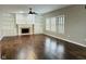 Spacious living room with a ceiling fan, hardwood floors, and windows with natural light at 14914 Annabel Ct, Westfield, IN 46074